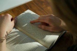 finger guiding through a page of a book